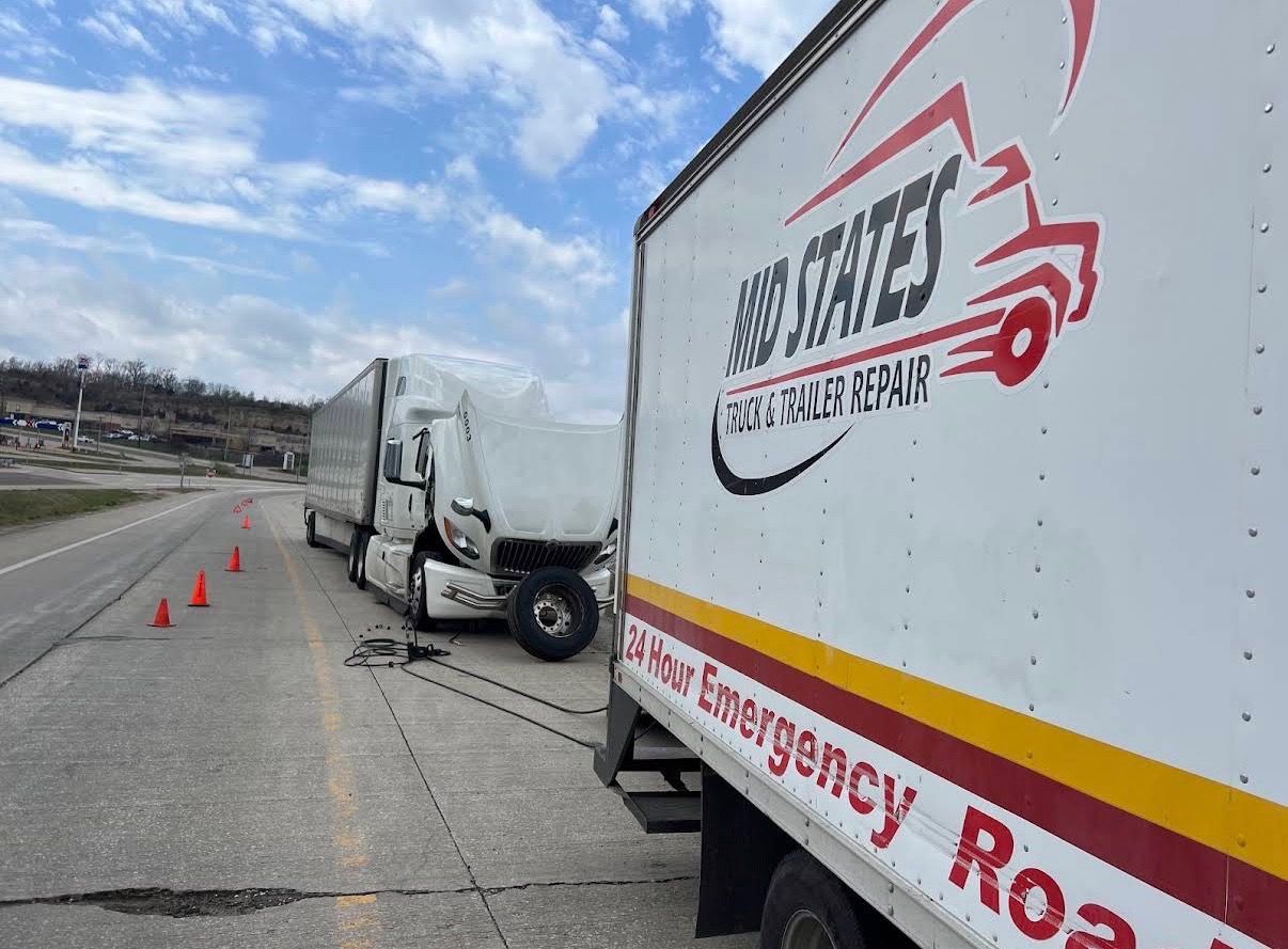 Mid States box truck on a 24-hour road call, hood up on a semi